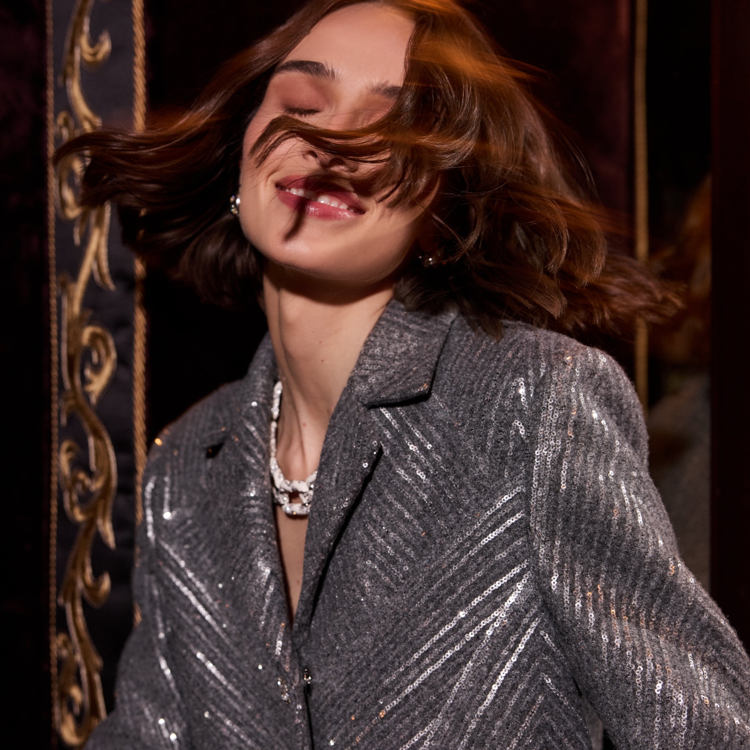 Woman wearing St John Knits Resort 2025 silver sequin knit jacket